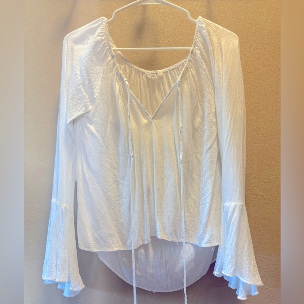 White Olvaceous blouse with bell sleeves.